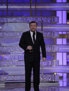Ricky Gervais holds a drinkas he gives a memorable Golden Globes presentation