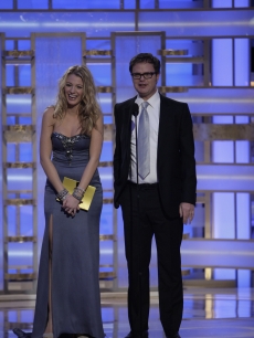 Blake Lively and Rainn Wilson share a laugh on stage at the Globes