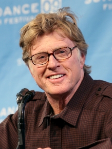 Robert Redford smiles for the press during Sundance’s opening day