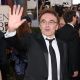 Director Danny Boyle waves to fans on the Globes red carpet
