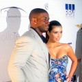 Reggie Bush and Kim Kardashian pose on the red carpet for the Moves Magazine Super Bowl party in Tampa