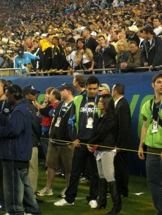 Frankie Delgado and Khloe Kardashian hang out on the field prior to the Super Bowl