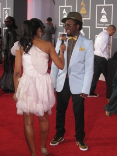 will.i.am gives a few bites to a reporter as he rushes into the Grammys last minute
