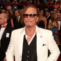 Best Actor nominee Mickey Rourke honors his dog on the Oscars red carpet