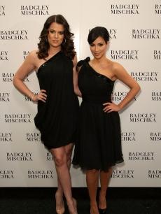 Khloe Kardashian and Kim Kardashian pose backstage at the Badgley Mischka Fall 2009 fashion show 
