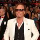 Best Actor nominee Mickey Rourke honors his dog on the Oscars red carpet