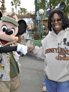Whoopi Goldberg is greeted by Mickey Mouse at the Disneyland Resort