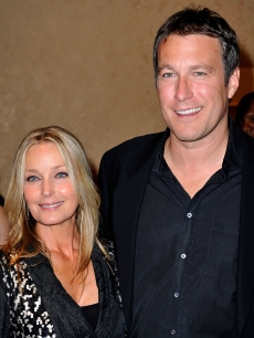 Bo Derek and John Corbett pose during the cocktail reception at the 30th anniversary Carousel of Hope Ball, October 2008