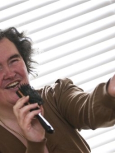 Susan Boyle, who’s performance on the television show “Britain’s Got Talent” wowed the judges, poses singing with a hairbrush at her home in Blackburn, Scotland, Thursday April 16, 2009