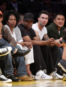 Denzel Washington sits next to his wife Pauletta (left) and Maroon 5 singer Adam Levine at the Lakers/Rockets game on May 17, 2009