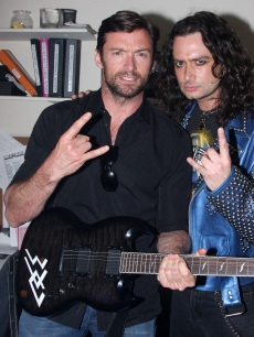 Hugh Jackman and Constantine Maroulis pose backstage at the hit musical ‘Rock of Ages’ on Broadway at The Brooks Atkinson Theater on May 21, 2009 in New York City