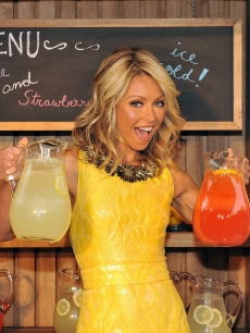 Kelly Ripa is all smiles in yellow during the Kelly Ripa and Electrolux Virtual Lemonade Stand Campaign announcement on June 8, 2009 in New York City