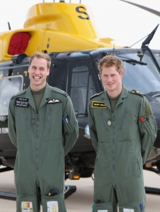 Prince William and Prince Harry show a little brotherly love in front of a Griffin helicopter during a photocall at RAF Shawbury on June 18, 2009 in Shawbury, England