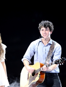 Miley Cyrus and Nick Jonas take the stage at the new Cowboys Stadium on June 20, 2009 in Dallas, Texas
