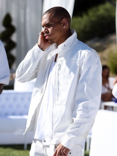 Chris Brown takes a call at Diddy and Ashton Kutcher’s White Party to benefit Malaria No More in LA on July 4, 2009