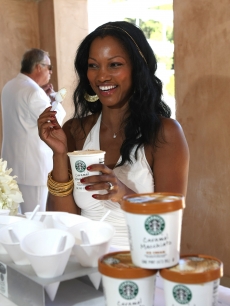 Garcelle Beauvais-Nilon chows down during Diddy’s annual White Party for Malaria No More in LA on July 4, 2009 