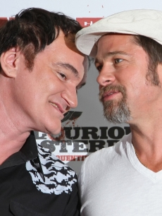 Director Quentin Tarantino and Brad Pitt share a moment on the red carpet during a photocall for ‘Inglourious Basterds’ at the Adlon Hotel in Berlin, Germany on July 28, 2009 