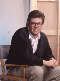 John Hughes in his director’s chair in 1990